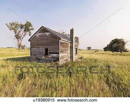 Stock Photography - Dilapidated wooden house in rural field.. Fotosearch