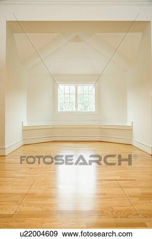 Stock Photo - Empty room in house with sunlight coming through window on hardwood floors. Fotosearch