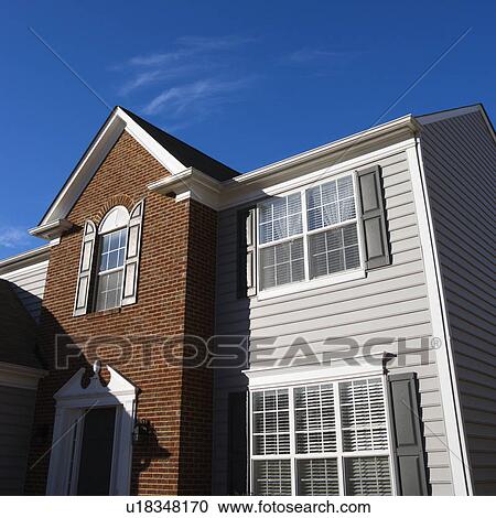 Stock Image - Exterior of brick and vinyl siding house. Fotosearch