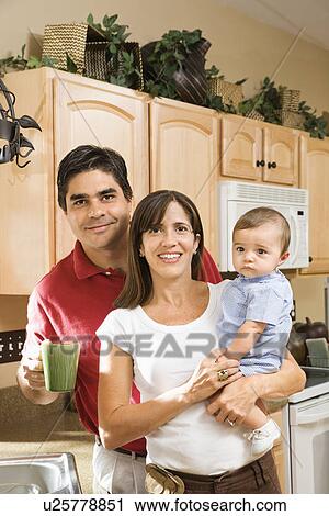 Family in home kitchen with baby View Large Photo Image Stock Image - Family in home kitchen with baby . Fotosearch