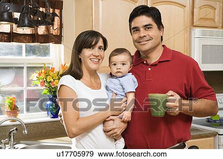 Stock Photo - Family portrait in home kitchen with baby. Fotosearch