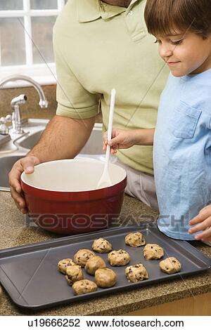 Father and son in kitchen making cookies View Large Photo Image Stock Image - Father and son in kitchen making cookies. Fotosearch