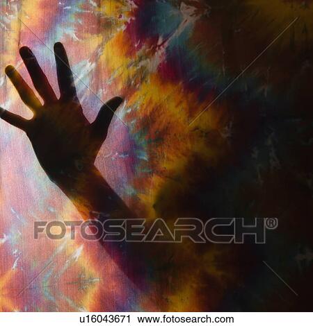 Female hand silhouetted behind tye-dye fabric. View Large Photo Image Stock Image - Female hand silhouetted behind tye-dye fabric.. Fotosearch