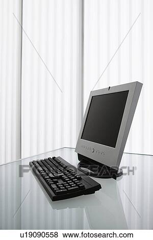 Stock Photo - Flat screen computer monitor and keyboard on a desk.. Fotosearch