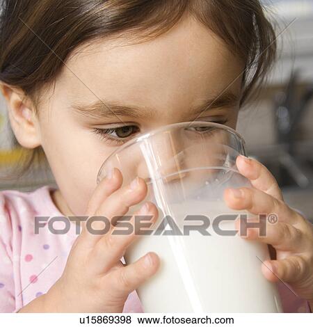 Girl drinking glass of milk View Large Photo Image Stock Photo - Girl drinking glass of milk. Fotosearch
