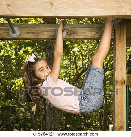 Girl hanging by arms and legs from monkey bars View Large Photo Image Stock Image - Girl hanging by arms and legs from monkey bars. Fotosearch