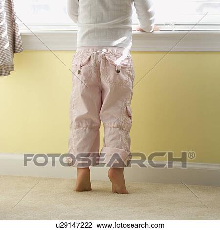 Girl standing on tip toes looking out window View Large Photo Image Stock Image - Girl standing on tip toes looking out window. Fotosearch