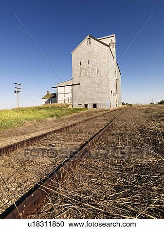 Stock Image - Grain Elevator and railroad tracks.. Fotosearch
