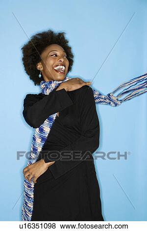 Half length studio portrait of smiling happy woman flinging scarf over shoulder on blue background. View Large Photo Image Stock Photo - Half length studio portrait of smiling happy woman flinging scarf over shoulder on blue background.. Fotosearch