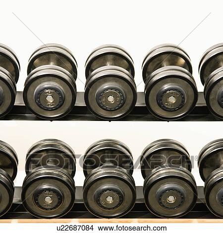 Picture - Hand weights on rack at health club. Fotosearch