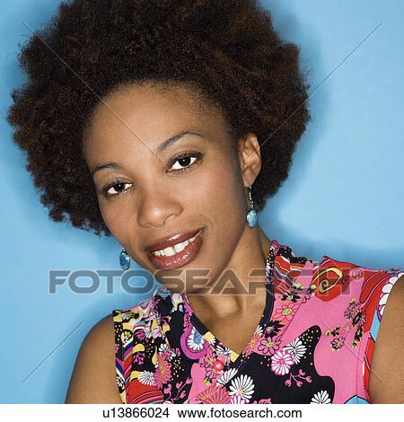 Head and shoulder portrait of woman with afro wearing vintage print fabric. View Large Photo Image Picture - Head and shoulder portrait of woman with afro wearing vintage print fabric.. Fotosearch