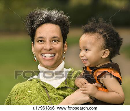 Head and shoulder portrait of woman holding boy and smiling. View Large Photo Image Stock Photograph - Head and shoulder portrait of woman holding boy and smiling.. Fotosearch