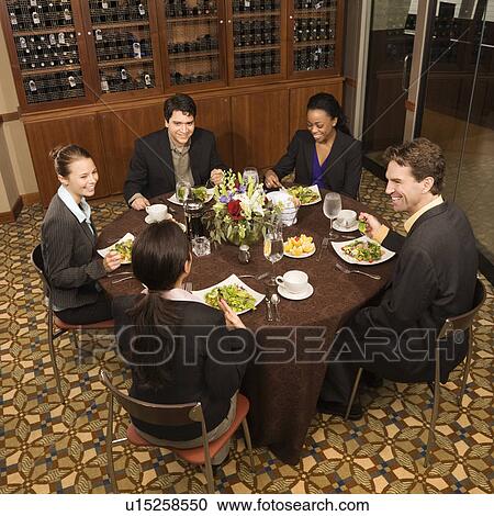 High angle of group of businesspeople in restaurant dining View Large Photo Image Stock Image - High angle of group of businesspeople in restaurant dining. Fotosearch