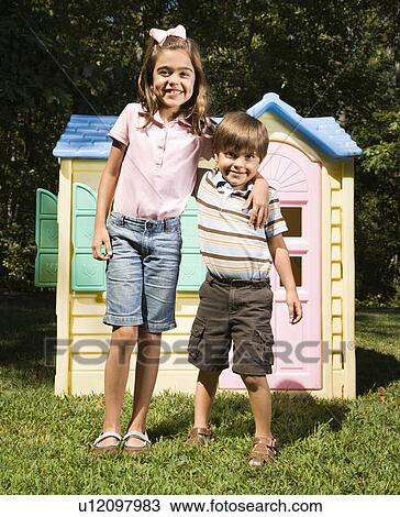Hispanic boy and girl in front of outdoor playhouse smiling at viewer. View Large Photo Image Stock Image - Hispanic boy and girl in front of outdoor playhouse smiling at viewer.. Fotosearch