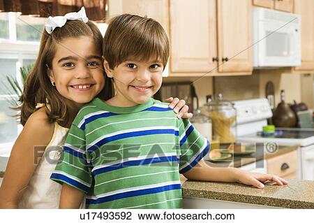 Hispanic children in kitchen smiling at viewer. View Large Photo Image Stock Image - Hispanic children in kitchen smiling at viewer.. Fotosearch