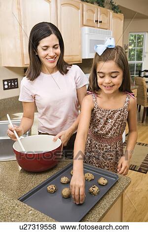 Hispanic mother and daughter in kitchen making cookies. View Large Photo Image Stock Photo - Hispanic mother and daughter in kitchen making cookies.. Fotosearch