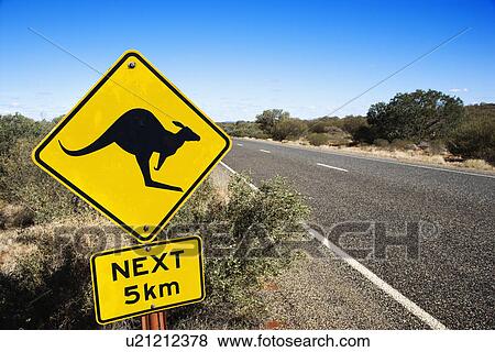 Kangaroo crossing sign by road in rural Australia. View Large Photo Image Stock Photo - Kangaroo crossing sign by road in rural Australia.. Fotosearch
