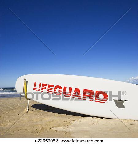Stock Image - Lifeguard surfboard on beach in Surfers Paradise, Australia.. Fotosearch