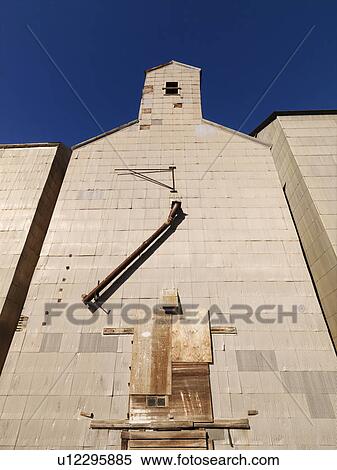 Stock Photography - Low angle of abandoned metal grain elevator. Fotosearch