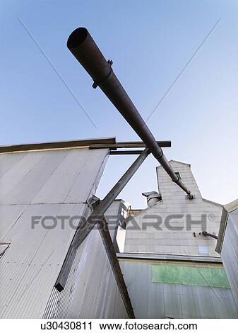 Stock Image - Low angle of grain elevator. Fotosearch