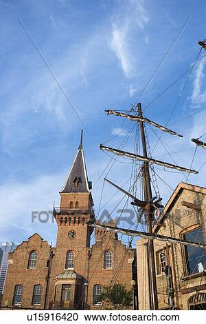 Stock Image - Low angle view of Australian Steam Navigation Company building and mast of sailboat in Sydney, Australia.. Fotosearch