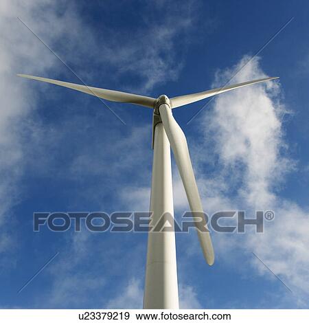 Low angle view of wind turbine against blue sky and clouds. View Large Photo Image Stock Photo - Low angle view of wind turbine against blue sky and clouds.. Fotosearch