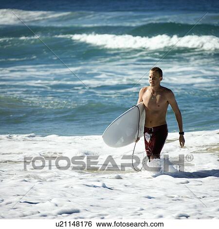 Male walking ocean carrying surfboard in Surfers Paradise, Australia View Large Photo Image Stock Photograph - Male walking ocean carrying surfboard in Surfers Paradise, Australia. Fotosearch