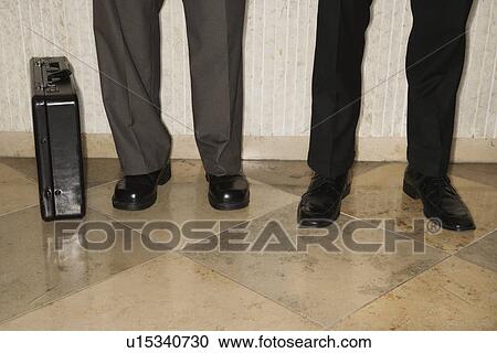 Stock Image - Male's legs and briefcase . Fotosearch