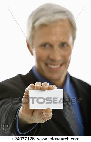 Stock Photograph - Man holding business card. Fotosearch