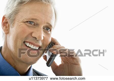 Stock Photo - Man smiling and talking on cell phone. Fotosearch
