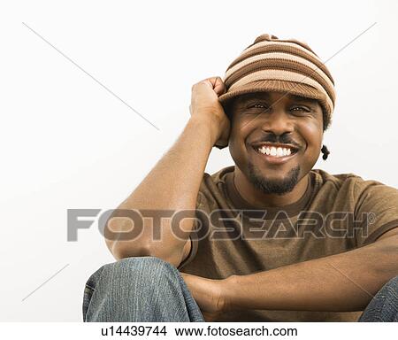 Picture - Man wearing knit hat smiling. Fotosearch