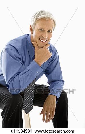 Stock Image - Man with hand to chin. Fotosearch