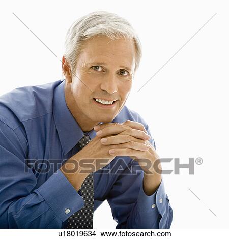 Picture - Man with hands folded in front smiling at viewer. Fotosearch