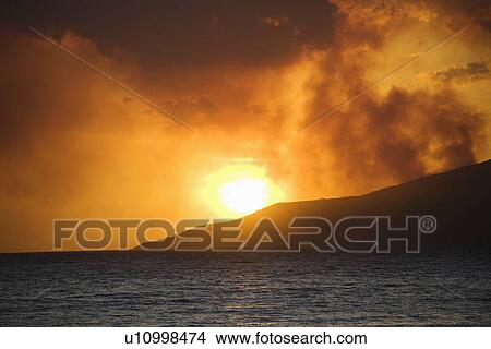 Picture - Maui, Hawaii sunset with ocean and island mountain on Maui, Hawaii.. Fotosearch