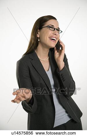Mid adult professional business woman talking on cell phone with hand out and smiling View Large Photo Image Stock Photograph - Mid adult professional business woman talking on cell phone with hand out and smiling. Fotosearch