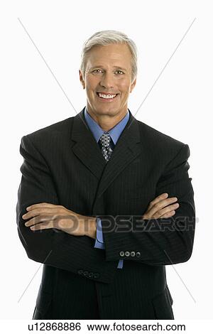 Middle aged Caucasian man in business suit smiling at viewer with arms crossed. View Large Photo Image Stock Photograph - Middle aged Caucasian man in business suit smiling at viewer with arms crossed.. Fotosearch
