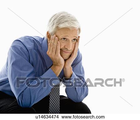 Middle aged man with head resting in hands looking bored View Large Photo Image Picture - Middle aged man with head resting in hands looking bored. Fotosearch
