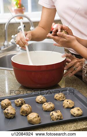 Picture - Mother and child in kitchen making cookies. Fotosearch