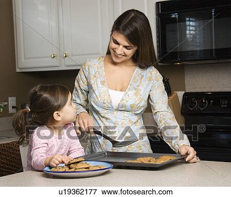 Stock Photo - Mother and daughter with cookies. Fotosearch