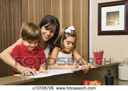 Stock Photograph - Mother helping children with homework. Fotosearch