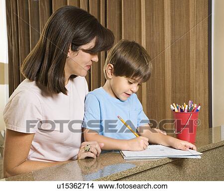 Mother helping son with homework View Large Photo Image Picture - Mother helping son with homework. Fotosearch