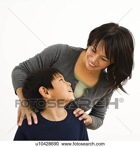 Stock Image - Mother smiling at young son. Fotosearch