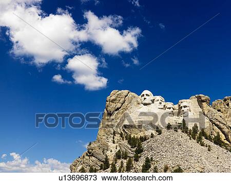 Mount Rushmore National Memorial with blue cloudy sky View Large Photo Image Stock Image - Mount Rushmore National Memorial with blue cloudy sky. Fotosearch