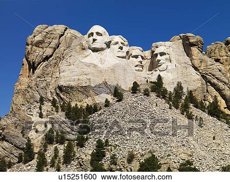 Stock Image - Mount Rushmore National Memorial with mountain and trees. Fotosearch