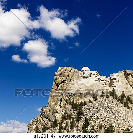 Stock Photo - Mount Rushmore National Memorial with blue cloudy sky.. Fotosearch