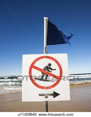 Stock Image - No surfing sign and flag on beach at Surfers Paradise, Australia.. Fotosearch