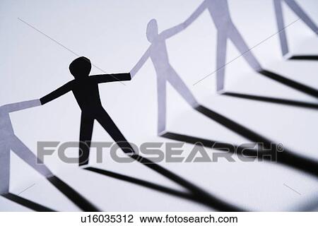 One black cutout paper person holding hands with group of white people. View Large Photo Image Stock Image - One black cutout paper person holding hands with group of white people.. Fotosearch
