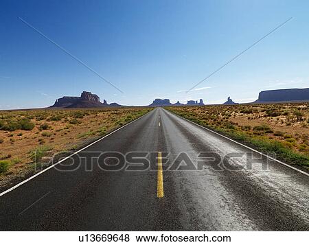 Open road in scenic desert landscape with distant mountains and mesas. View Large Photo Image Stock Photo - Open road in scenic desert landscape with distant mountains and mesas.. Fotosearch