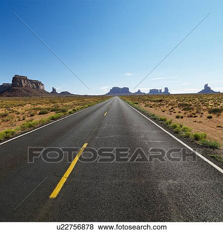 Open road in scenic desert landscape with distant mountains and mesas View Large Photo Image Stock Photo - Open road in scenic desert landscape with distant mountains and mesas. Fotosearch