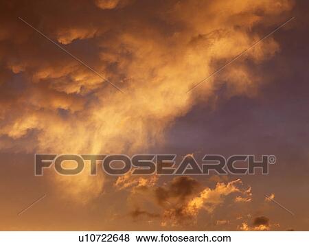 Orange-yellow clouds in sky at sunset. View Large Photo Image Stock Photo - Orange-yellow clouds in sky at sunset.. Fotosearch
